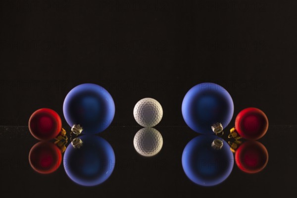 Golf ball and Christmas decoration on the glass table