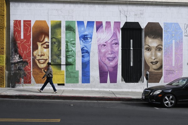 Passers-by in front of a Hollywood sign, Hollywood, Los Angeles, California, USA, North America