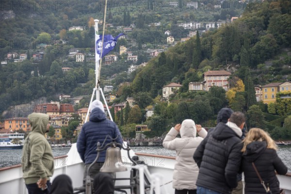 VARENNA, ITALY, OCTOBER 05, 2023, Tourists waiting for the ferry to dock at the harbor of Varenna, lake Como