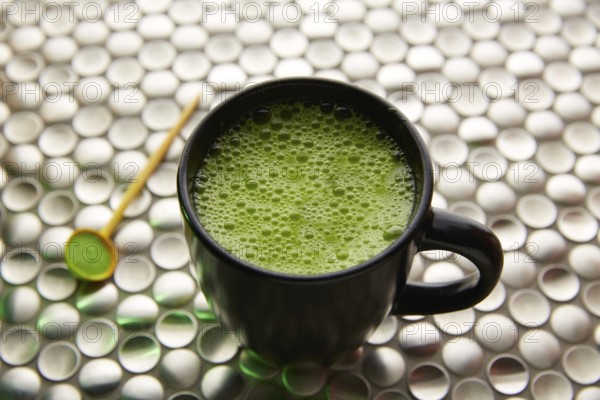 Matcha green tea from Japan on modern stainless steel background