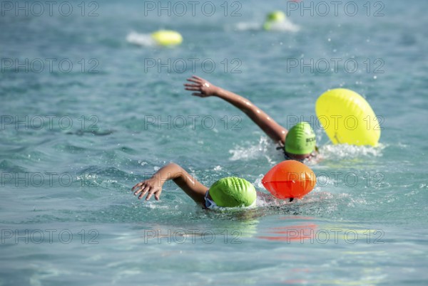 Athletes swimming free style in the sea during race competition. Aquathlon Swimmer in the ocean