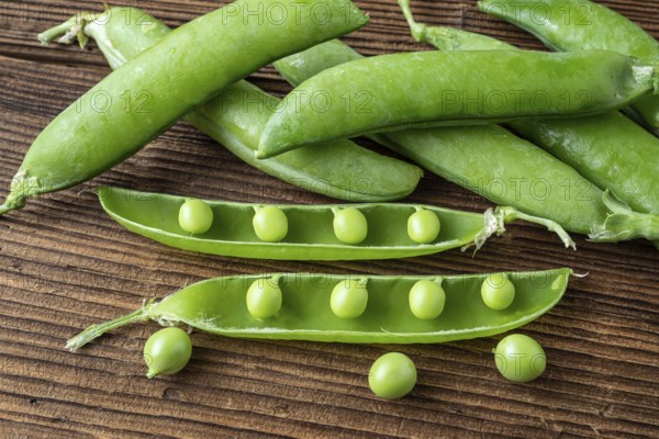 Few green peas on black background