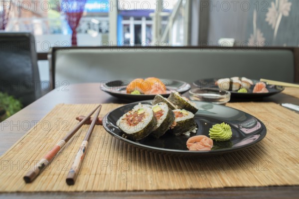 Sushi in sushi bar. Table and ration sushi