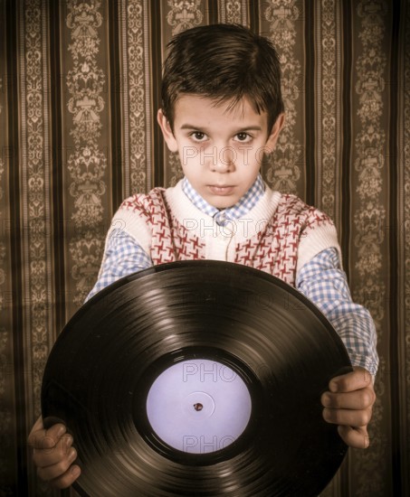 Child hold lp. Vontage clothes