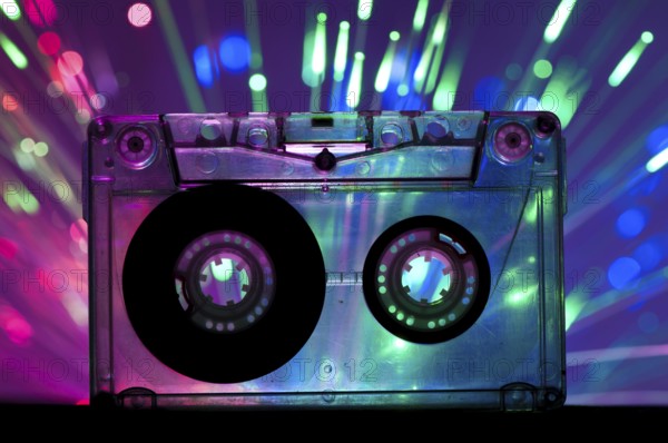 Transparent Cassette tape and blue pink color disco light background