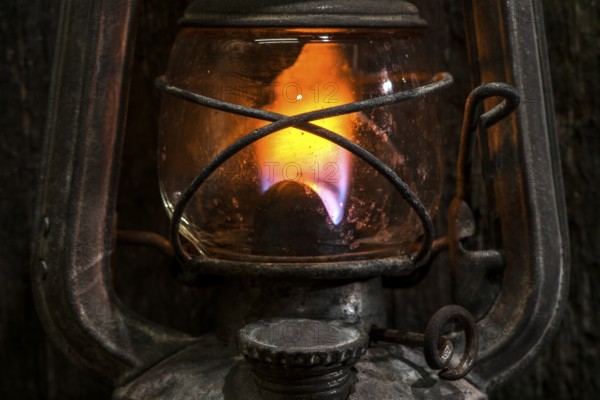 Old gas lantern on wood at darkness