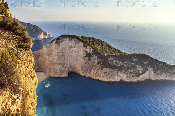 Summer holidays in Greece. Magic island on the Mediterranean Sea. The sky glows a warm sunset. The concept of a summer beach holiday and photo tourism