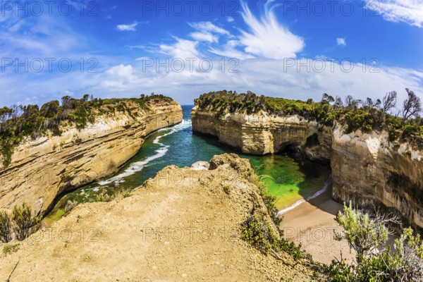 Small picturesque bay with green ocean water. The Great Ocean Road of Australia. The Pacific ocean. The concept of exotic, active and photo-tourism