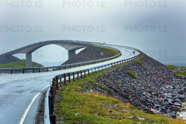 Scenic bridge over the ocean. Atlantic Road: the most beautiful road in the world. Cold and stormy July day. Rain over the famous bridge in the icy sea. Norway