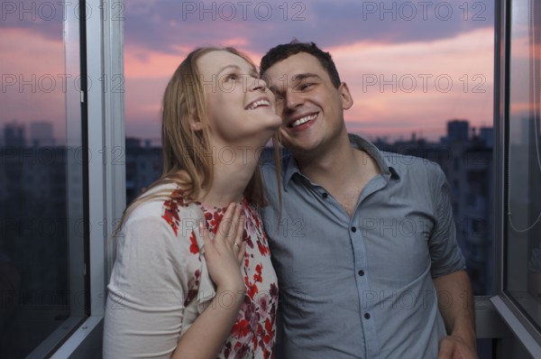 Playful young couple enjoying their new own apartment