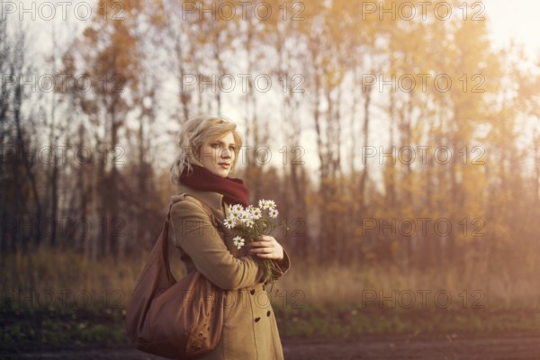 Young beautiful woman in the park in autumn season