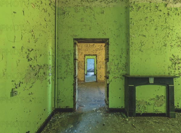 Dilapidated room with bright green wall colour and old fireplace, Prison H11, Lost Place, Verviers, Province of Liège, Belgium, Europe