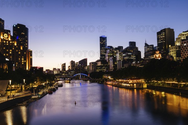MELBOURNE, AUSTRALIA - OCTOBER 10, 2024: Melbourne skyline from Princes Bridge in Southbank along the Yarra River at dusk in Victoria, Australia, Oceania