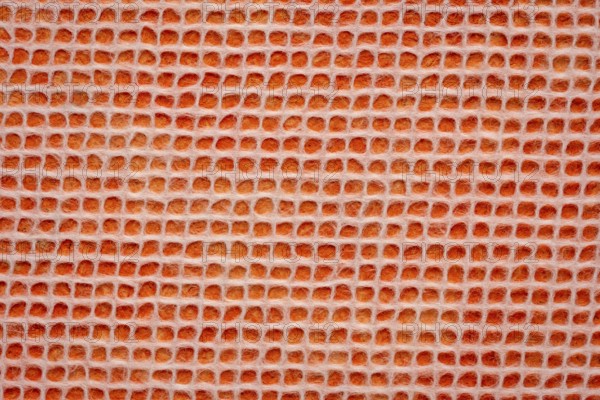 White Thai mulberry lace paper with a grid pattern against orange background