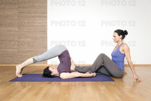 An image of some people doing yoga exercises