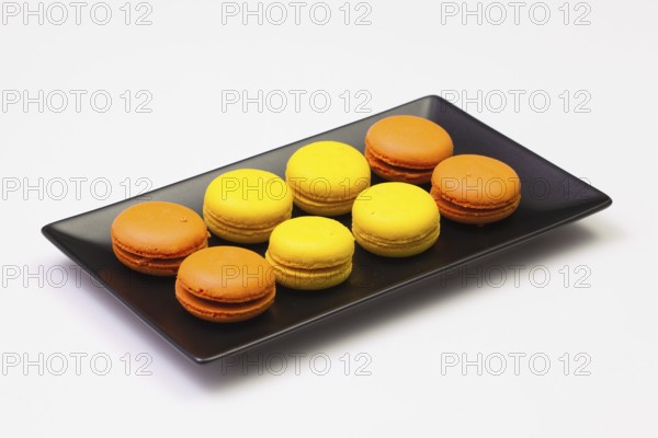 Traditional french colorful macarons on the black plate