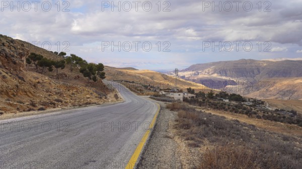 Road in mountainous terrain near At Tafilah, Jordan, Dead Sea at distant background, Asia