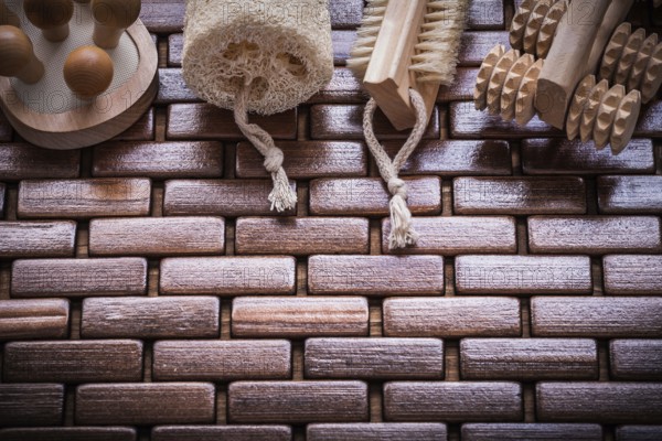 Wood peeling brush massagers and loofah on checked wooden place mat healthcare concept