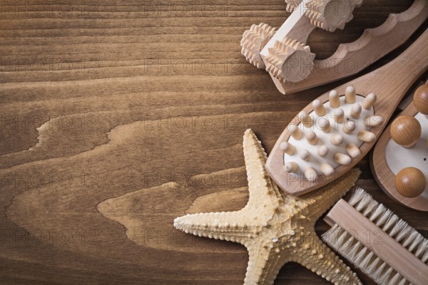 Set of massagers starfish and scrubbing brush on pine vintage board healthcare concept