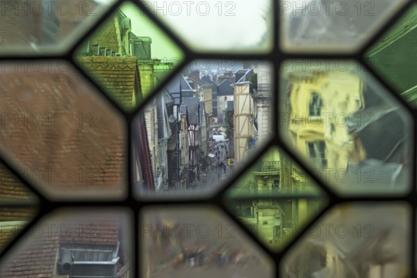 Rouen, France, August 30, 2018: View of the city street through the old window on the clock tower (Gros-Horloge) . Rouen, Normandy, France, Europe