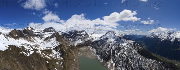 Aerial view on Ritom lake between snow-capped mountains at spring, Switzerland alps, panorama