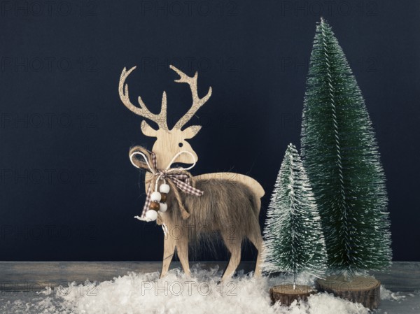Christmas decoration wooden reindeer with fir trees