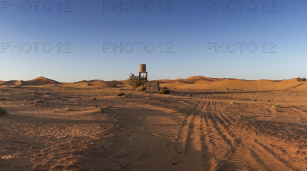 View of offroad vehicle tracks leading into the sand dunes of Erg Chebbi in the Sahara Desert of Morocco