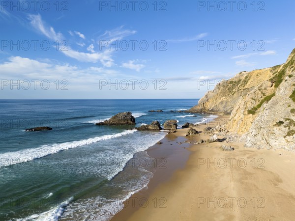 Adraga Beach and Cliffs on Sunny Day. Atlantic Ocean, Portugal. Aerial View