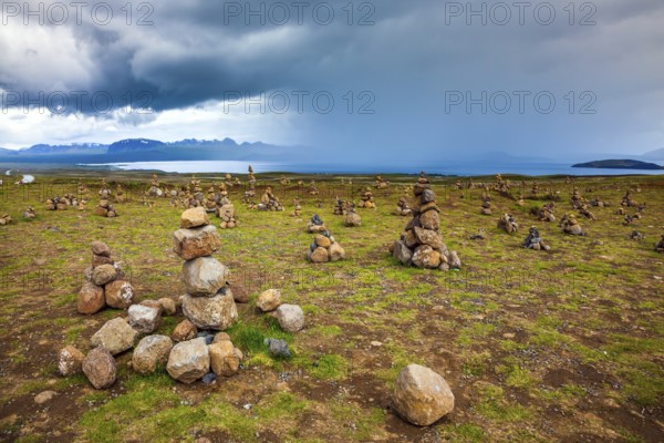 Stone pyramids bring good luck in the journey. The stone pyramids are a symbol of Iceland. Field of stone pyramids. Cloudy summer cold day. The concept of active, ecological and exotic travel