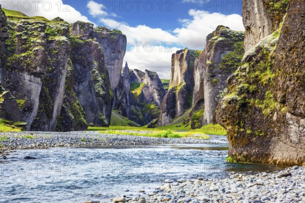 Steep cliffs, overgrown with green moss, surrounded by a very fast river with cold water. Magic beauty canyon