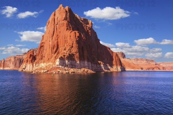 Lake Powell is surrounded by magnificent sandstone hills. Scenic huge artificial water basin of the Colorado River, USA. Walk on the boat at sunset