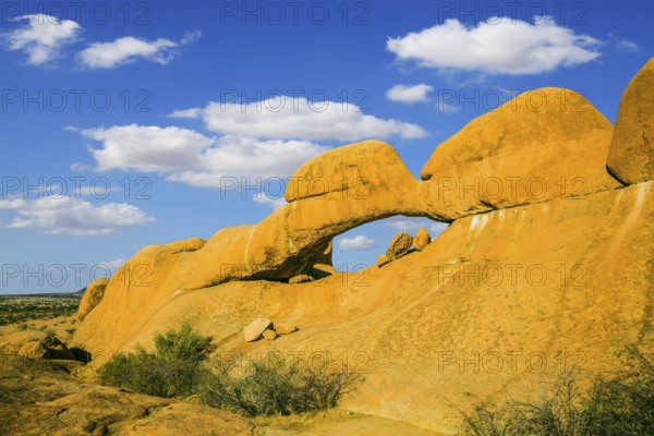 Mountain Nature Reserve in the desert. Stone arch Spitzkoppe, Namibia. The concept of extreme and ecological tourism