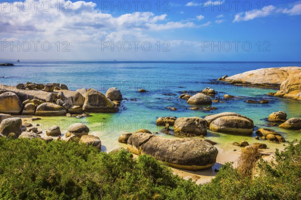 Huge boulders on the beach of the Atlantic Ocean. Boulders Penguin Colony in the Table Mountain National Park, South Africa. The concept of ecotourism