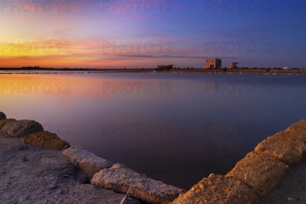 Landscape view of calm sea salt basins and flats near Trapani and Paceco at sunset