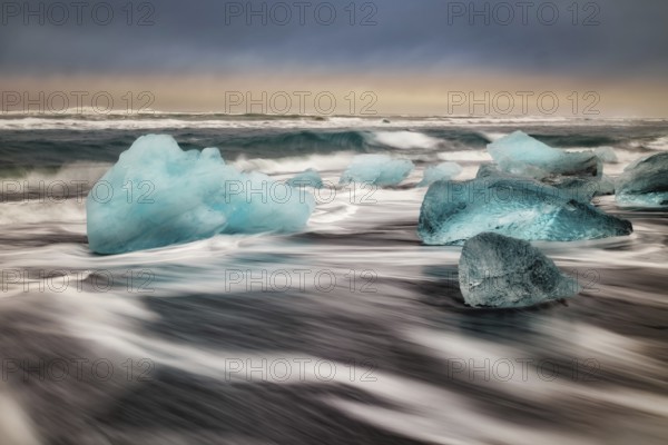 Ice floes on the black sea sand and the coast Jokulsarlon