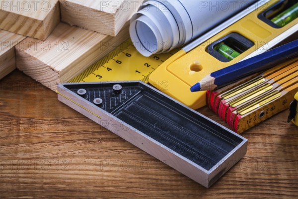 Square ruler pencil blueprints wooden meter and studs construction level on vintage wood board maintenance concept