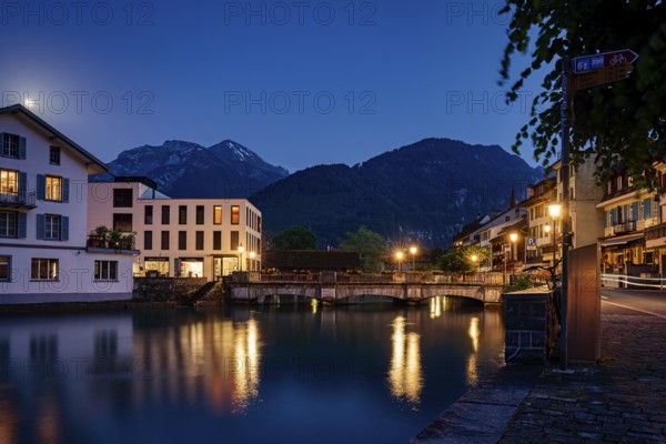 Tranquil night scene with reflections on a lake and mountains in the background, city, vilage, cityscapes, streets, old architecture, old buildings, Interlaken, Switzerland, Europe