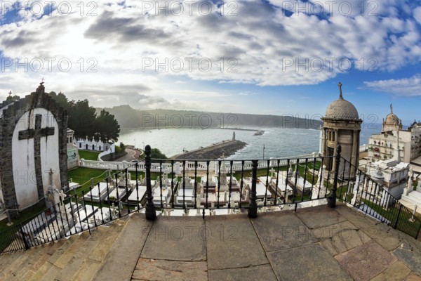 Ancient cemetery over a cliff to the Atlantic Ocean. Luarca is the most beautiful small town in Asturias. Picturesque fishing port in the bay. Romantic trip to Spain
