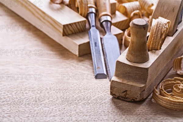 Veri close up view old fashioned plane chisels planks shavings on wooden board