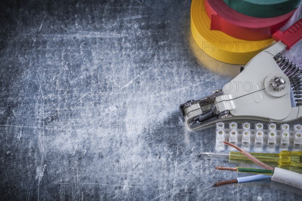 Electrician's set on scratched metallic background copy space electricity concept