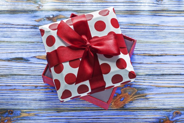 Opened wrapped present box on vintage wooden board