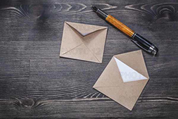 Vintage envelopes fountain pen on wooden board