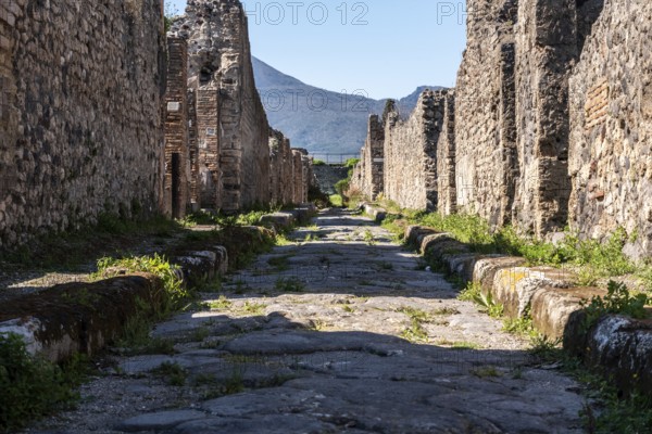 POMPEII, ITALY, MAY 04, 2022, A beautiful typical cobbled street in the ancient city of Pompeii, Southern Italy