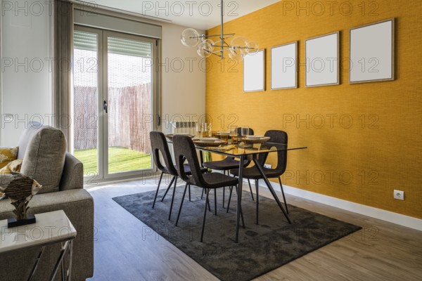 Stylish contemporary living room interior in white and yellow colors with sofa, table and posters on wall. Scandinavian interior design