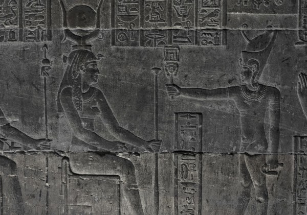 Hieroglyphic carvings on the wall of an ancient egyptian temple