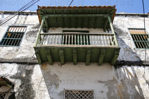 Low angle view of a green roofed balcony at an old house in Old Town Cartagena, Brazil, South America
