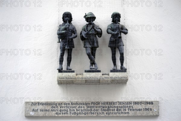 Munich, Germany - June 30, 2018: Three musicians sculptures and part of the old fish fountain above a memorial plaque in honour of Professor Herbert Jensen on 30 June 2018 in Munich