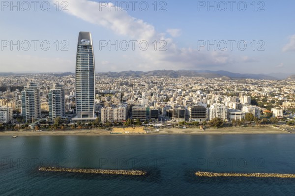 Drone aerial view of waterfront of modern coastal city with skyscrapers. Limassol town Cyprus Europe