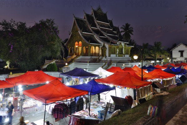 Night market in front of the Buddhist temple Haw Phra Bang of the Royal Palace, National Museum on Sisavangvong Road, Luang Prabang, Laos, Asia