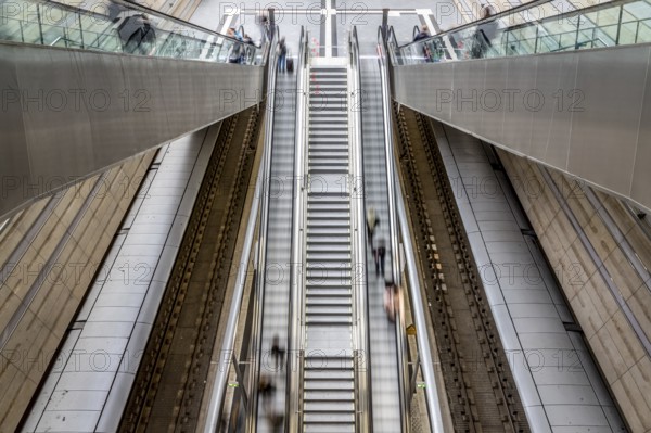 Escalator leads with motion blur through modern glass architecture, Leipzig Central Station